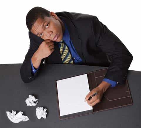 Clearly, this man at a desk with cumpled papers needs to find a ghostwriter. Hire us! :)